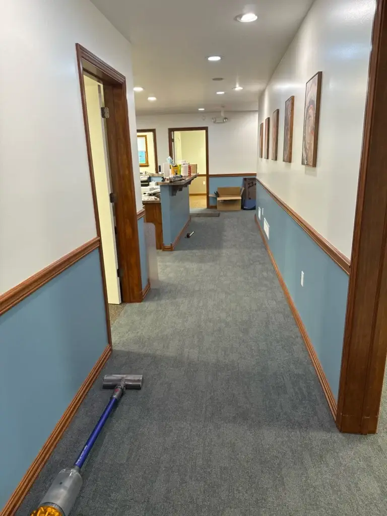 Freshly painted hallway with new carpet and framed artwork at Northumberland Hearing Center