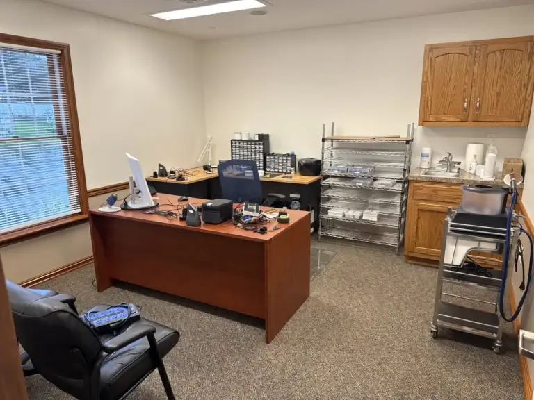 Hearing aid lab and repair room with workbench, parts storage and cleaning station at Northumberland Hearing Center