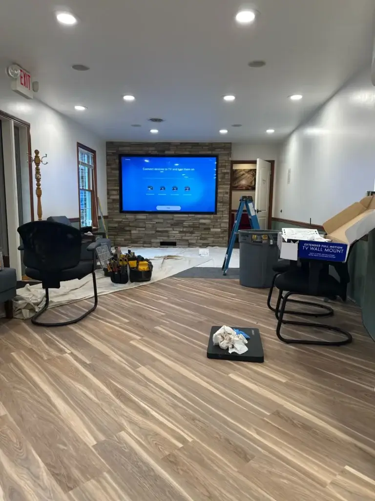 Remodeled waiting room with stone accent wall at Northumberland Hearing Center